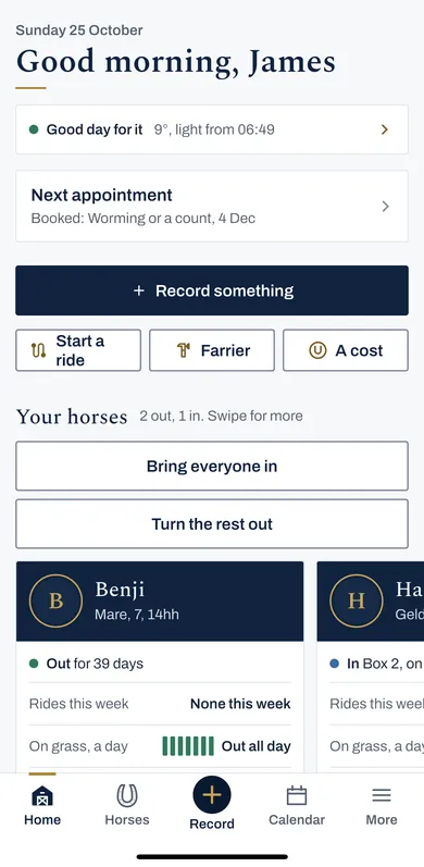 Home in the iPhone app for the example yard: Good morning, James, a good day for it, the next appointment, Record something with Start a ride, Farrier and A cost under it, then Your horses, 2 out and 1 in, with Bring everyone in, Turn the rest out, and Benji's card: out all day on grass.